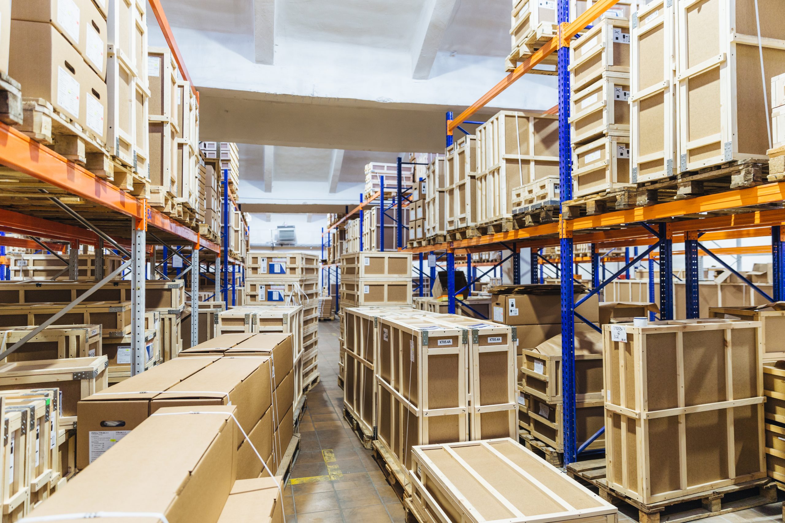 Large warehouse with stacked wooden crates and boxes.